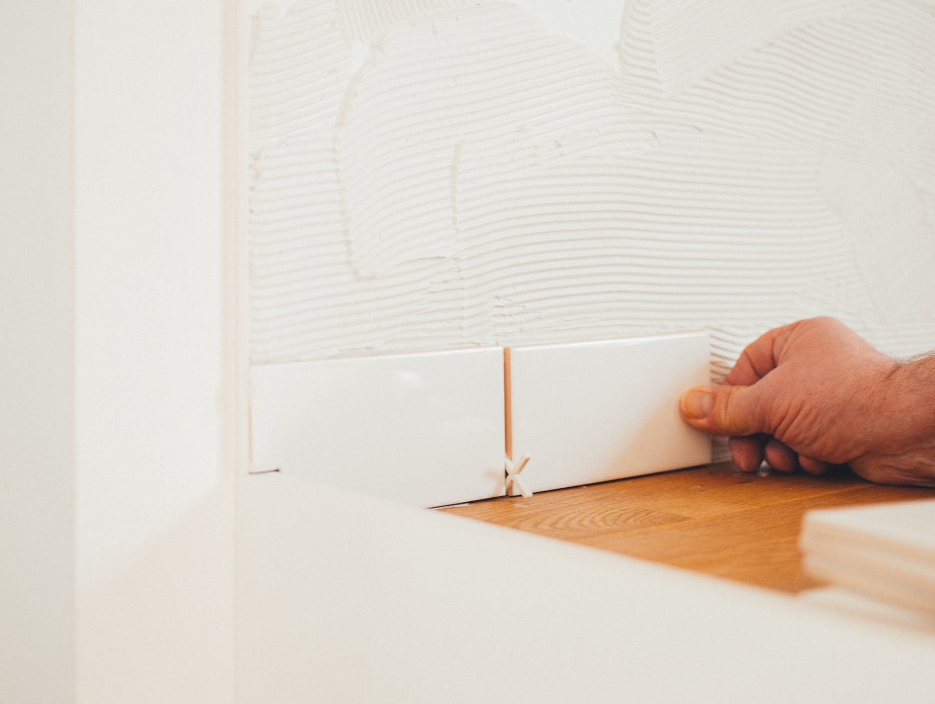 person holding white tile